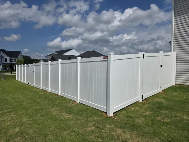 White vinyl privacy fence enclosing a back yard in a Triangle neighborhood, installed by Superior Fence & Rail of Raleigh